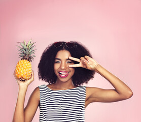 Portrait, woman and pineapple with peace, studio and detox food on pink background. Nutrition,...