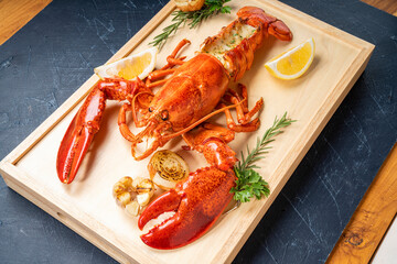 Grilled Lobster with Cheese on wooden plate, Grilled Canadian Lobster on wooden background.