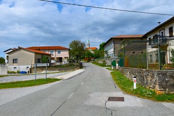 Street at Kostanjevia na Krasu village with a church above in Primorska, Slovenia