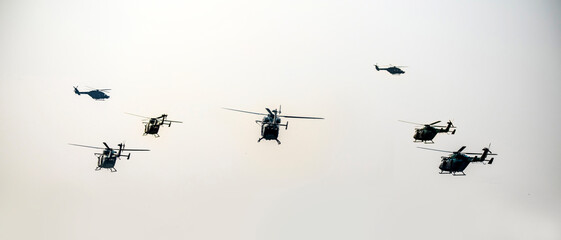 Obraz premium A group of helicopters are flying on isolated sky