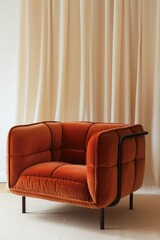 Contemporary Orange Armchair Against a Neutral Curtain Background