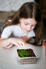 Girl study to plant seedlings for gardening at home. Spring season of gardening