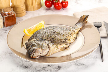 Baked Dorado fish served lemon