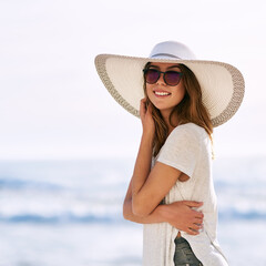 Sunglasses, happy and portrait of woman at beach for summer holiday, tourism and adventure in Miami. Outdoor, smile and relax by ocean with hat for travel, weekend trip and confidence on vacation - obrazy, fototapety, plakaty