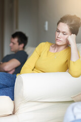 Stress, marriage and sad couple on sofa in home with anger, argument or fight in living room....