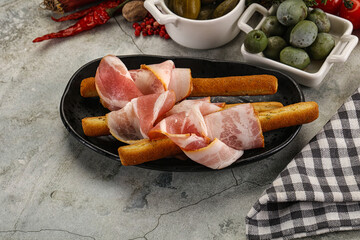 Antipasti - Grissini with pork bacon