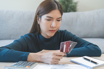 Business financial concept, stressed asian young business woman hand holding credit card for...