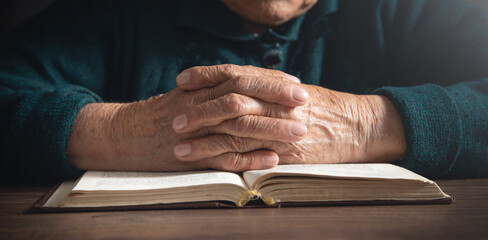 Caucasian elderly woman hands with bible.