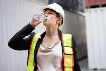 Portrait Happy caucasian logistic engineer pregnant woman working and drinking water at container...