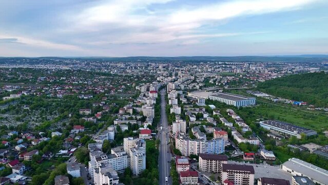 Aerial view captured from drone over city of Iasi from Romania with buildings, trees and traffic during an afternoon