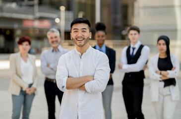 Confident Asian Businessman Leading a Diverse Corporate Team