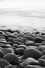 Close-up of pebble beach. Long exposure shots. Black and white.