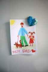 Photo postcard to the Best Dad drawn by a child. Attached with a blue heart magnet. White...