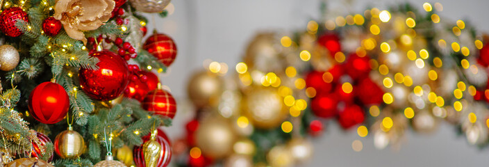 A Christmas tree decorated for the new year with toys and bows on a festive background. An...