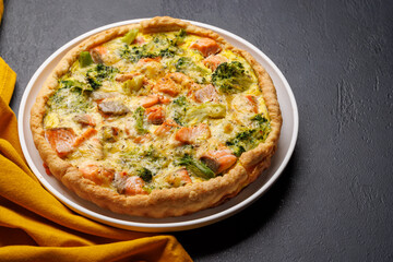 Homemade pie with salmon and broccoli