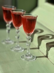 Pouring several glasses of Mexican Mezcal or Tequila shots. Classic Tequila small glasses being served.