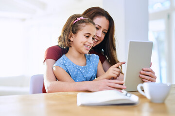 Mother, girl and tablet for learning at table, online play and remote homeschool or education in...