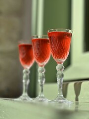 Pouring several glasses of Mexican Mezcal or Tequila shots. Classic Tequila small glasses being served.