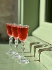 Pouring several glasses of Mexican Mezcal or Tequila shots. Classic Tequila small glasses being served.