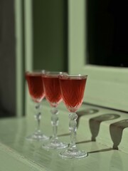 Pouring several glasses of Mexican Mezcal or Tequila shots. Classic Tequila small glasses being served.