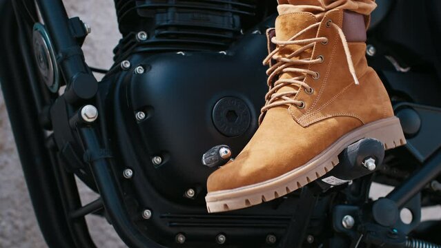 FLORIANOPOLIS, BRAZIL - MARCH 30, 2024: Person sits on the black Royal Enfield Classic 350 motorcycle and shifts the gear