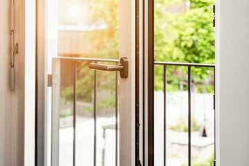 Window detail with Sunlight.  Modern Aluminum Open Window Safety Barrier Grate. Metal Door Frame....