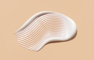 cosmetic smear of creamy texture on a beige background