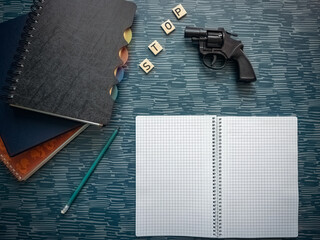 Stop guns message wood letters school supplies and gun on table copy space
