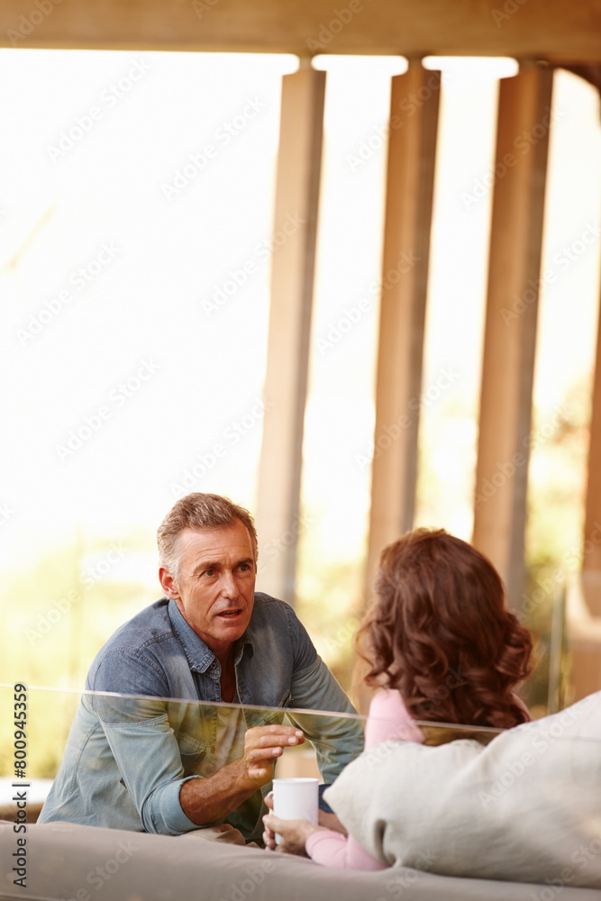 Canvas Prints Mature couple, talking and planning in living space with coffee, bonding and discussing life and marriage in day. Older man, woman and couch at home with together, important and serious conversation