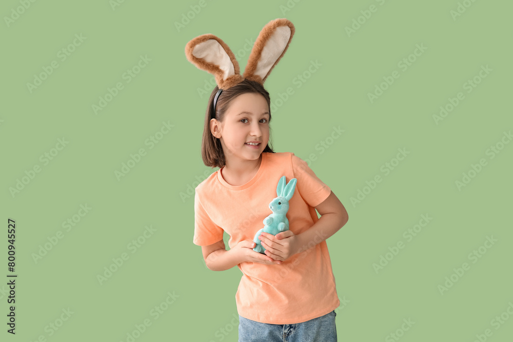 Sticker happy little girl in easter bunny ears with toy rabbit on green background