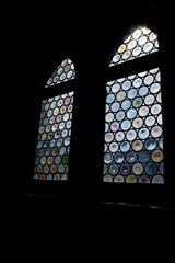 stained colored windows of a church illuminated by sunlight