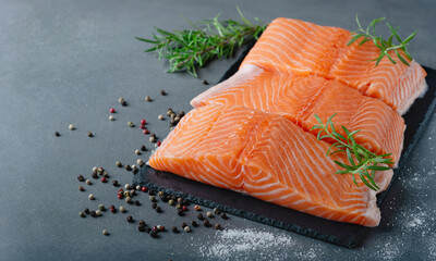 Raw salmon fillet and ingredients for cooking, seasonings and herbs, with copy space for text
