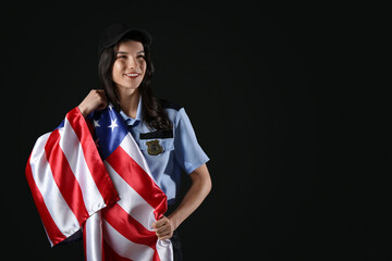 Female police officer with USA flag on black background