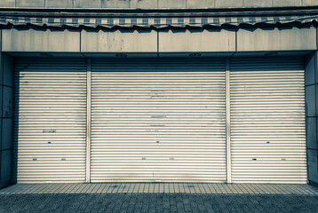 Closed steel shutter door of warehouse, storage or storefront for metal door background and...