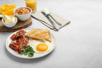 Delicious breakfast with sunny side up egg served on light table. Space for text