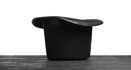 Magician's hat on wooden table against white background