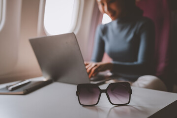 Airplane passengers, business people use laptops on the plane to work while sitting on the plane....