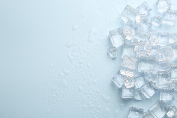 Crystal clear ice cubes on light blue background, flat lay. Space for text