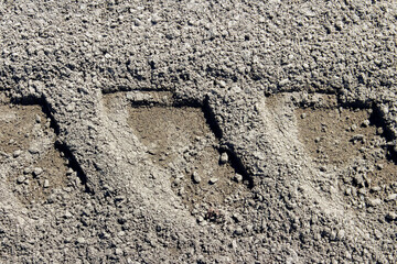 Close-up of large car tracks on a dirt road