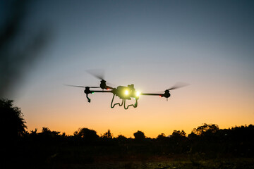 drone is flying over the field. twilight scene