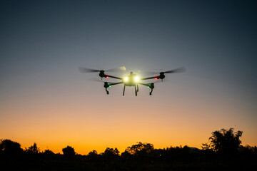 drone is flying over the field. twilight scene