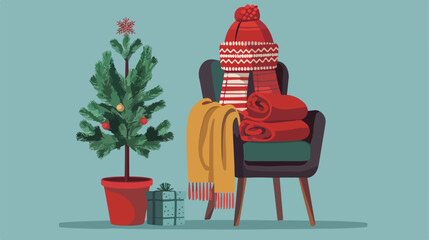 Winter clothes with fir tree on chair against color background