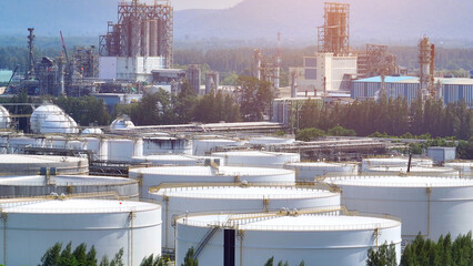 Aerial drone view captures the geometric precision of an oil depot, with rows of gleaming tanks and...