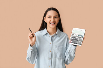 Beautiful young woman with calculator and pen on brown background