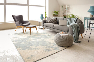 Stylish interior of white living room with black sofa and armchair