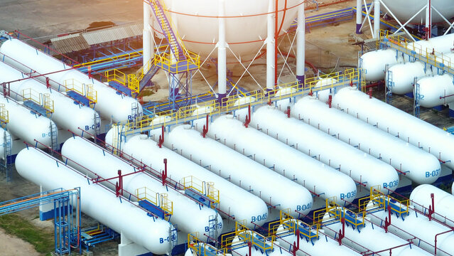 Aerial drone's perspective unveils the expansive natural gas storage, a labyrinth of tanks securing our energy future. Clean energy: Natural gas heats and powers. Energy and fuel concept. 
