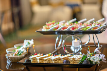 A variety of canapes on a silver platter.