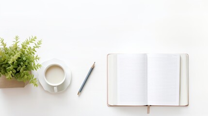 A beautiful workspace with a plant, coffee cup, pencil, and open notebook