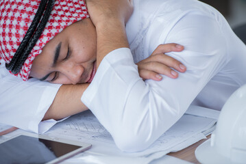 An arab businessman sleeping on his desk