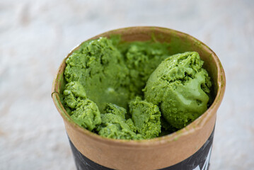 Matcha green tea ice cream in a brown cup